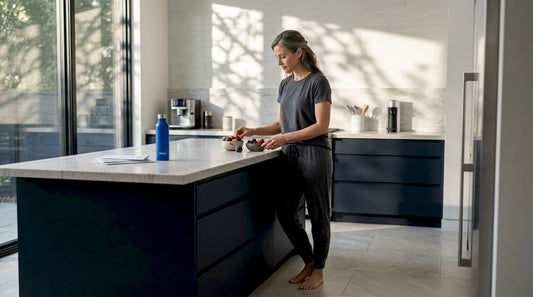 Woman selects fruit in a bright kitchen