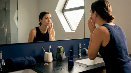 Woman doing skincare in bright bathroom