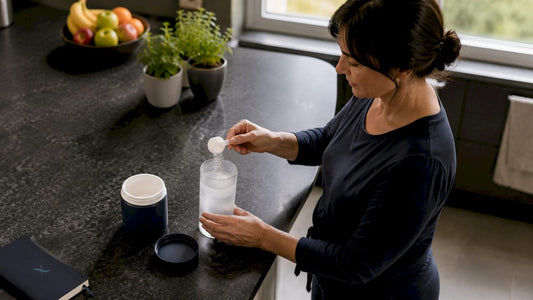 Person preparing magnesium powder supplement at kitchen table