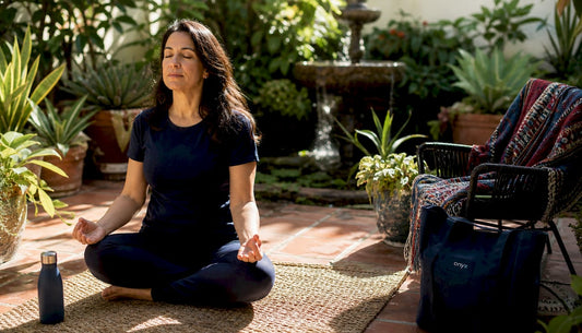 Woman meditating peacefully at home