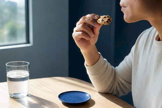 Adult slowly tasting a small cookie